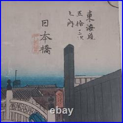 Japanese Woodblock print by Utagawa Hiroshige, titled Nihonbashi Morning Scene